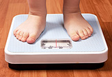 Child stepping on scale.