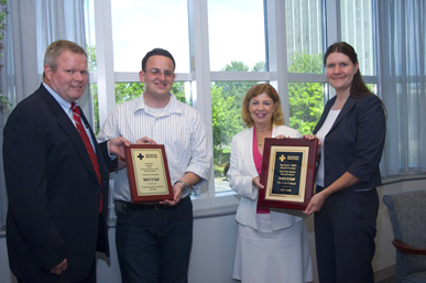 Nick Fahrenkopf and Vice President for Student Success Christine Bouchard, second and third from left, receive plaques from the American Red Cross. 