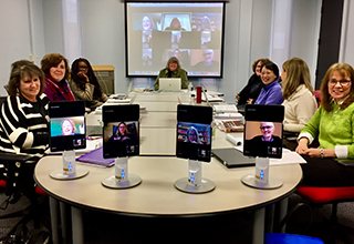 University at Albany School of Education professors sit at a confrence table using Kubi