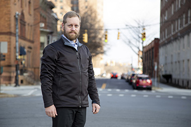 Erik Schlimmer '18 stands on Henry Johnson Boulevard.
