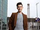 UAlbany senior Aleks Siemenn poses for a photo outside of University Hall on the Uptown Campus.
