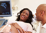 Pregnant woman having sonogram taken.