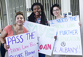Students holding signs at the rally. 