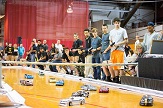 Students race RC cars around a gym in live Ten80 competition. 