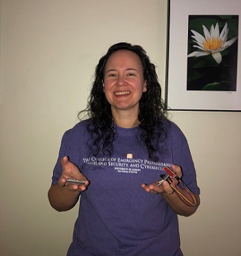 CEHC student Valerie Fullarton holds up car sensors that will be used in Ten80's virtual competitions. 