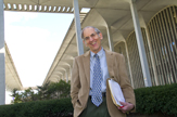 Distinguished Teaching Professor Jeffrey Berman smiles on the Podium