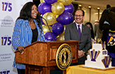 UAlbany's Student President, at lecturn, gets a smile out of President Rodríguez 
