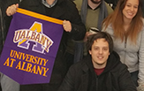 students with UAlbany banner