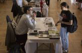 A student gets information on a research opportunity at the CURCE Fall Fair.
