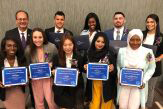 President Rodriguez stands with 9 SUNY Chancellor Award-winning students