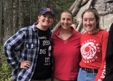 Three UAlbany female studnts pose in the coastal woods of Newfoundland.