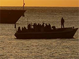 A migrant boat is intercepted by an Australian Navy ship near Australia's Christmas Island