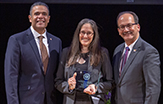 Elena Gordis of Psychology holds her Exemplary Public Engagement Award, flanked by Alfredo Medina, Jr., of public engagement, and President Rodríguez