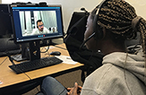 Lionel Tchatchoua Ngaleu, at right, speaks by Skype with a student from the Université de Haute-Alsace in France