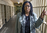Former inmate turned author Susan Burton poses outside a prison cell