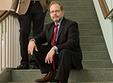 Jason Lane sits on the interior steps of the Science Library