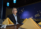 University at Albany professor and immigration expert Zai Liang of Sociology sits in a modern suburban-based Chinese restaurant