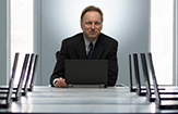 Peter Shea, UAlbany Asst. Provost of online learning, sits amid rows of computers