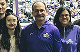 President Havidán Rodríguez and his wife, Rosy Lopez, at a UAlbany basketball game with students from China.