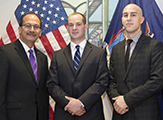 President Rodriguez stands with 2 new police department recruits