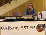 Photo of UAlbany SSTEP president Ali Hansen tabling in the Campus Center.