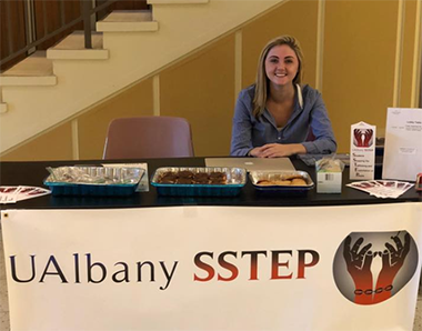 Photo of UAlbany SSTEP president Ali Hansen tabling in the Campus Center.