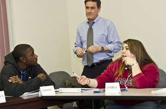 William Brigham listens as a student makes a point.