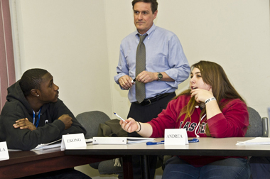 Two students with YEA! Academy instructor William Brigham
