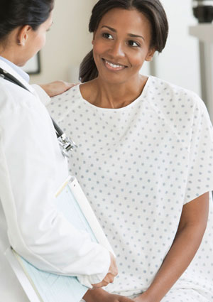 African American woman speaking to doctor