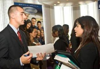 A student talks with a recruiter at a job fair at UAlbany.