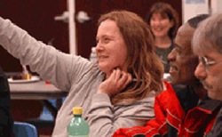 Woman raising hand in a class at COTS.  