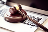 a laptop and gavel of justice