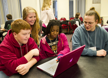 Students looking at computer University at Albany NY