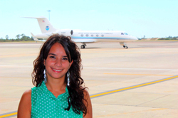 UAlbany doctoral student Rosimar Rios-Berrios standing in front of the G-IV aircraft.