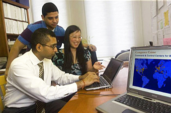Associate professor Sanjay Goel and students