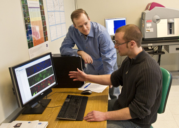 Don Matthews, standing, and Jan Baumann, seated, have won highly competitive fellowships to conduct cancer research.  
