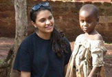 UAlbany senior and TWI President Nishtha Modi with a child in Uganda.