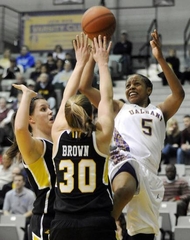 Ebone Henry passes over two UMBC defenders in March 10 America East Title win