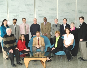 UAlbany School of Public Health researchers stand in front of the Wall of Memory and Hope in the Cancer Research Center.