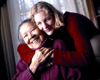 UAlbany social worker supporting older woman, smiling