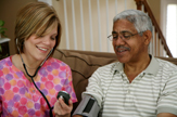 Medical home health aide assists a patient