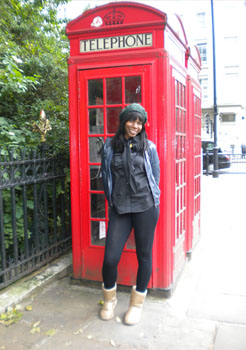 UAlbany public policy major Gina Geffrard in front of a red phone booth in England.