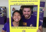Student volunteers pose in a sign that says Center for Leadership and Service