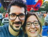 Charalampos Chelmis and his wife, Daphney-Stavroula Zois, in front of hot air balloons at the Adirondack Balloon Festival last September.