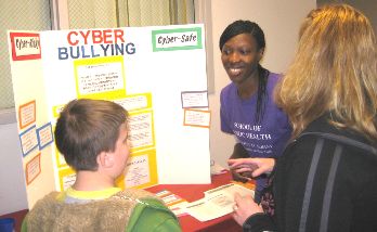 First year UAlbany MPH student Eziafa Oduah assists at the East Greenbush YMCA