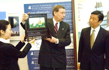 UAlbany President Kermit L. Hall accepts a gift from Party Secretary Li Yuanchao of Jiangsu Province. 