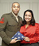 Former Resident Assistant Andre Williams presented the flag to Rosann Santos, Alumni Quad coordinator for Residential Life.