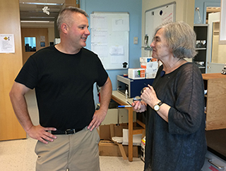 University at Albany biologist Thomas Begley and Marlene Belfort discuss things in a lab
