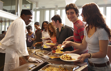 UAlbany students laughing while in line for food at the dining hall