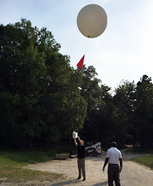 ASRC researchers prepare to launch a weather balloon over the Long Island Sound.
